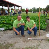 High School agriculture students posing in front of a garden with a new irrigation system.