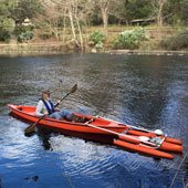 Ross Davis collecting data in a kayak at Fanning Springs
