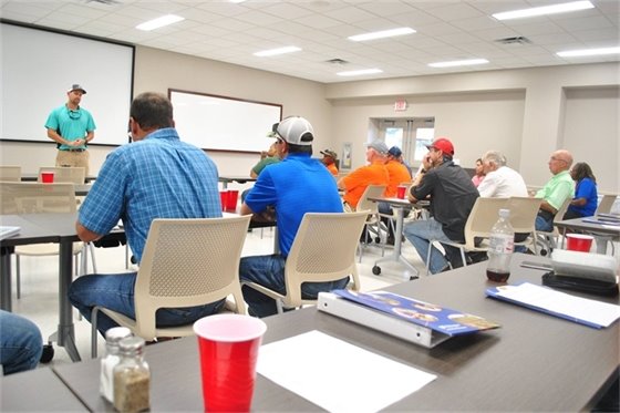 District staff presenting to a room full of stakeholders.